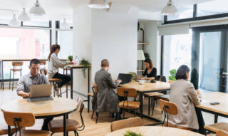 istockphoto-1154411652-612x612 serviced office Coworkers sitting at tables independently and using laptops, digital nomad, hot desking, freelancing